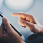 Cropped,Image,Of,Male,Hands,Using,Modern,Smartphone,In,Aircraft,